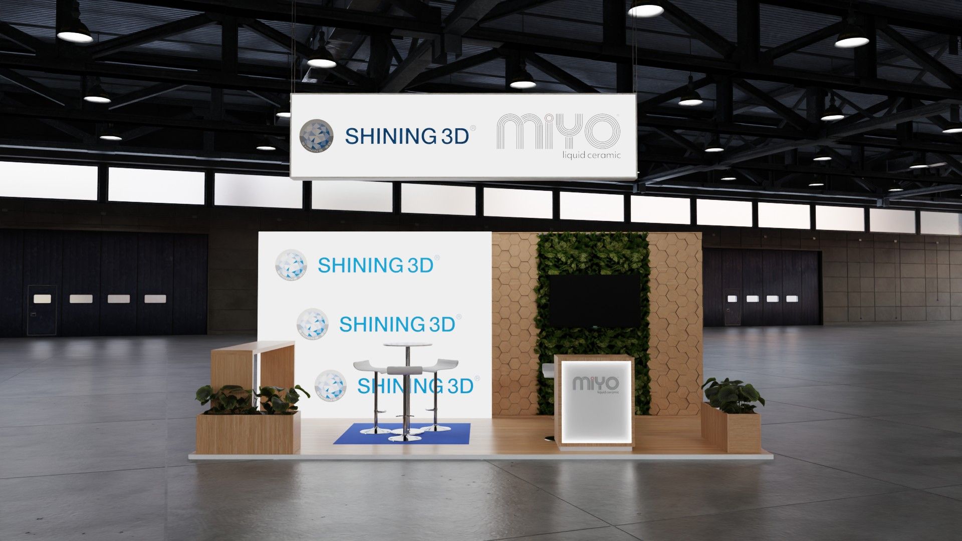 Stand SHINING 3D e MiYO de frente, com caixa de luz de logótipos SHINING 3D à esquerda e a parede de jardim vertical com ecrã à direita.